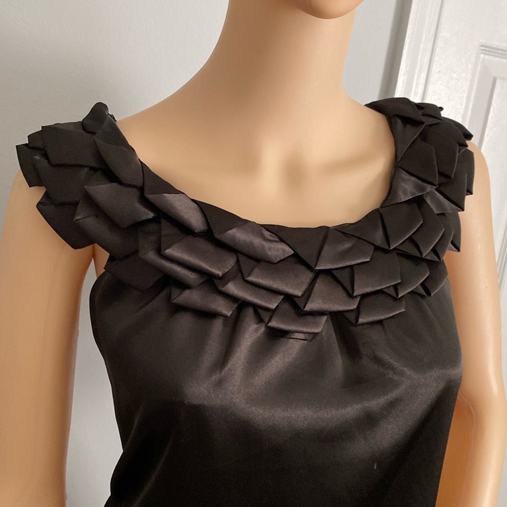 Black satin sleeveless top with stylish neckline.
